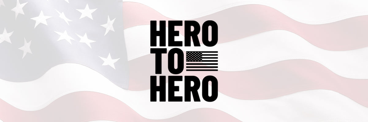 Text Hero to Hero with a small American flag on a faded, waving silk United States flag background.