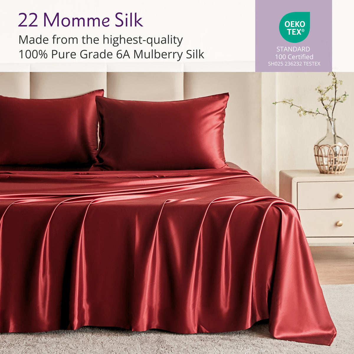 Red silk bedding set on a bed with a neutral background, featuring Oeko-Tex certification.