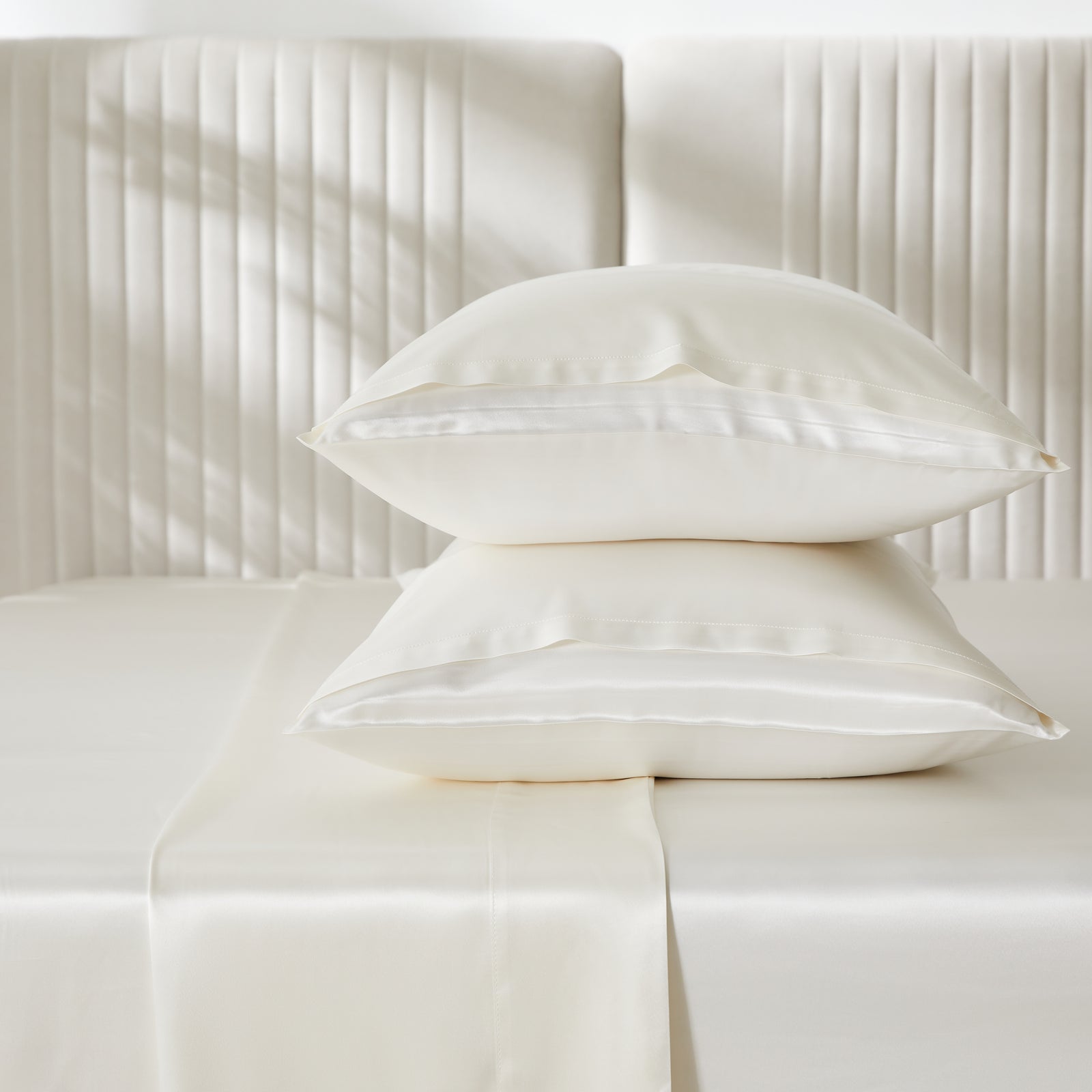 Elegant 22 Momme Silk Sheets Set in Ivory color displayed on a beautiful bed with 2 silk pillows