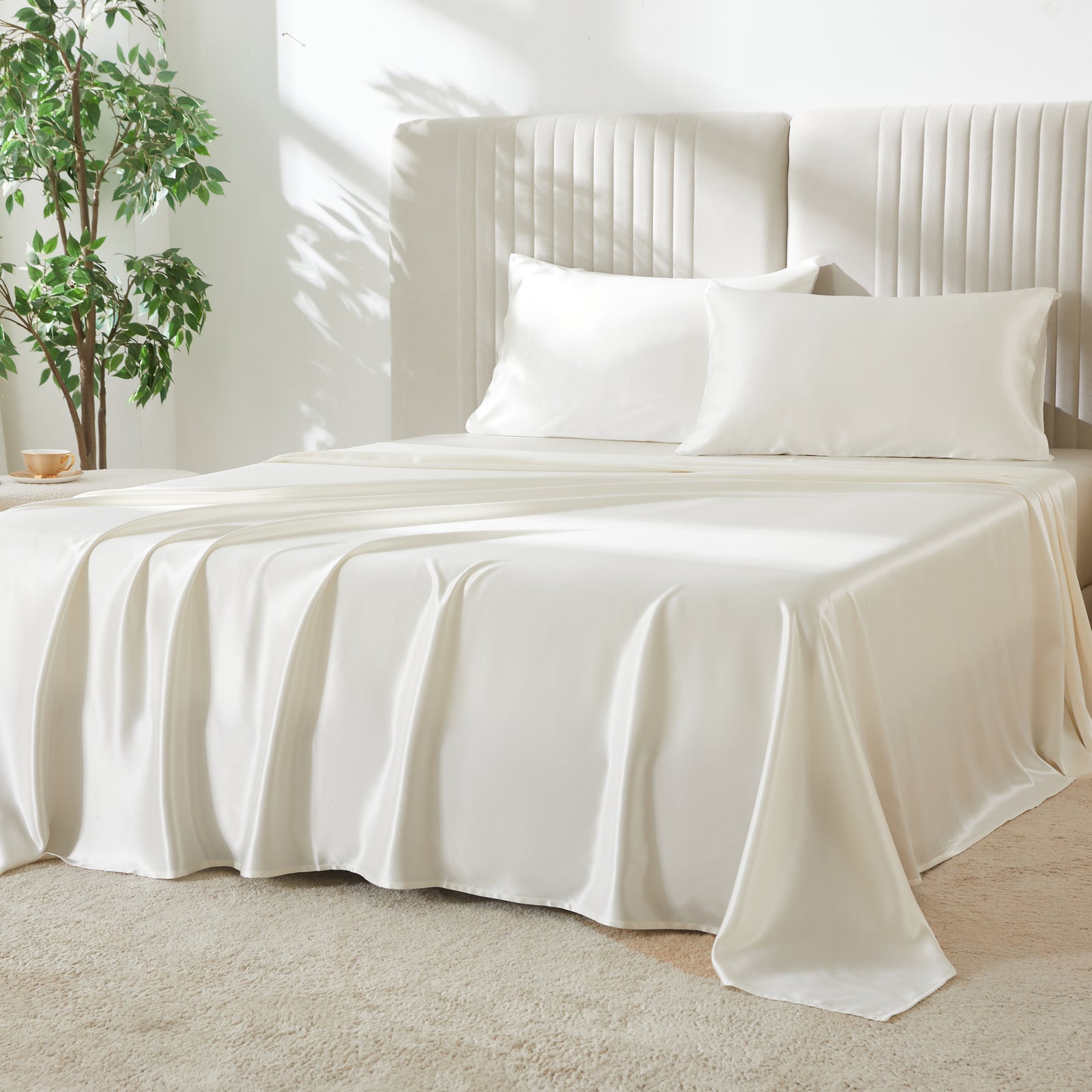 Elegant 22 Momme Silk Sheets Set in Ivory color displayed on a beautiful bed with 2 silk pillows