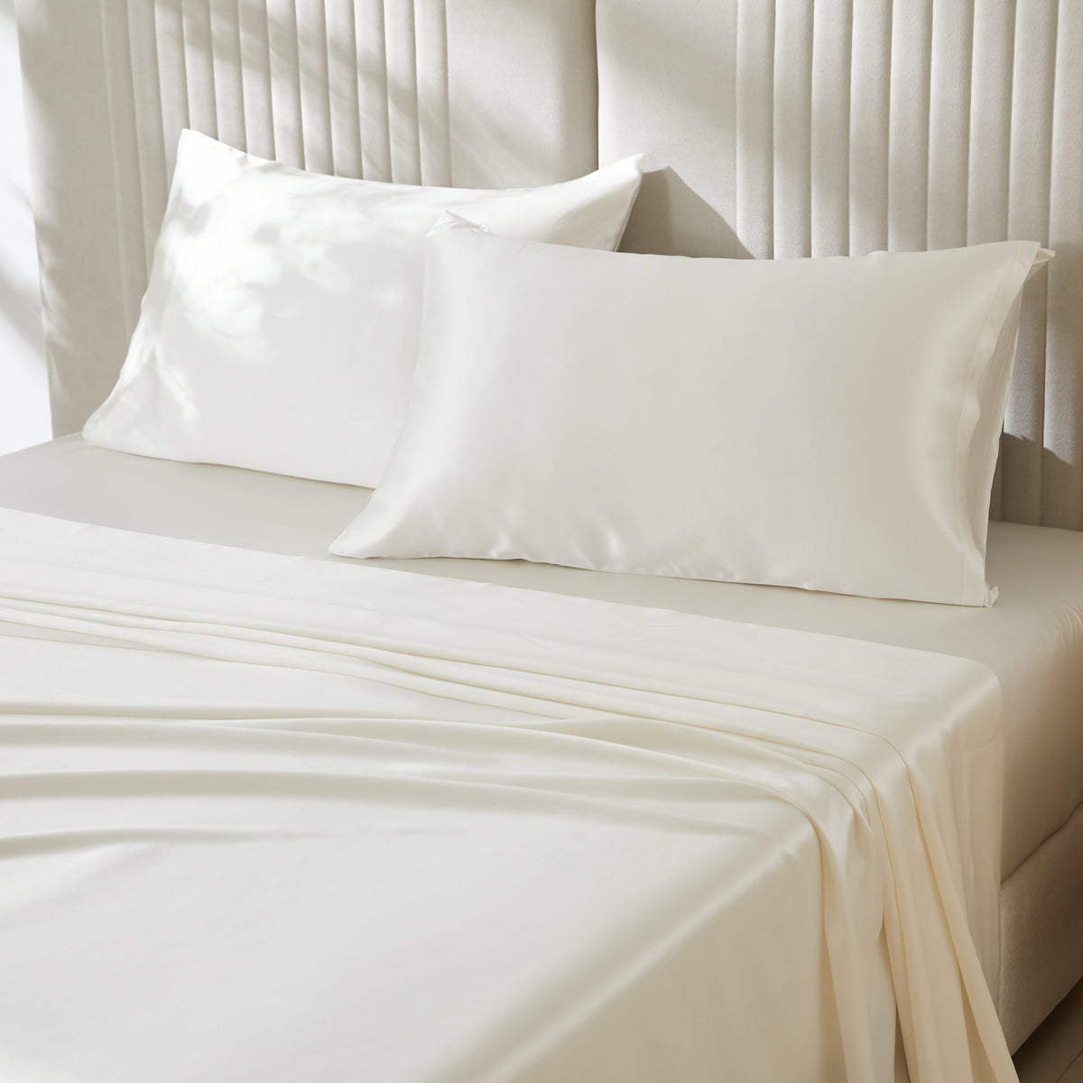 Ivory Silk Pillowcase with a Smooth, Glossy Finish, Placed on the Headboard Bed