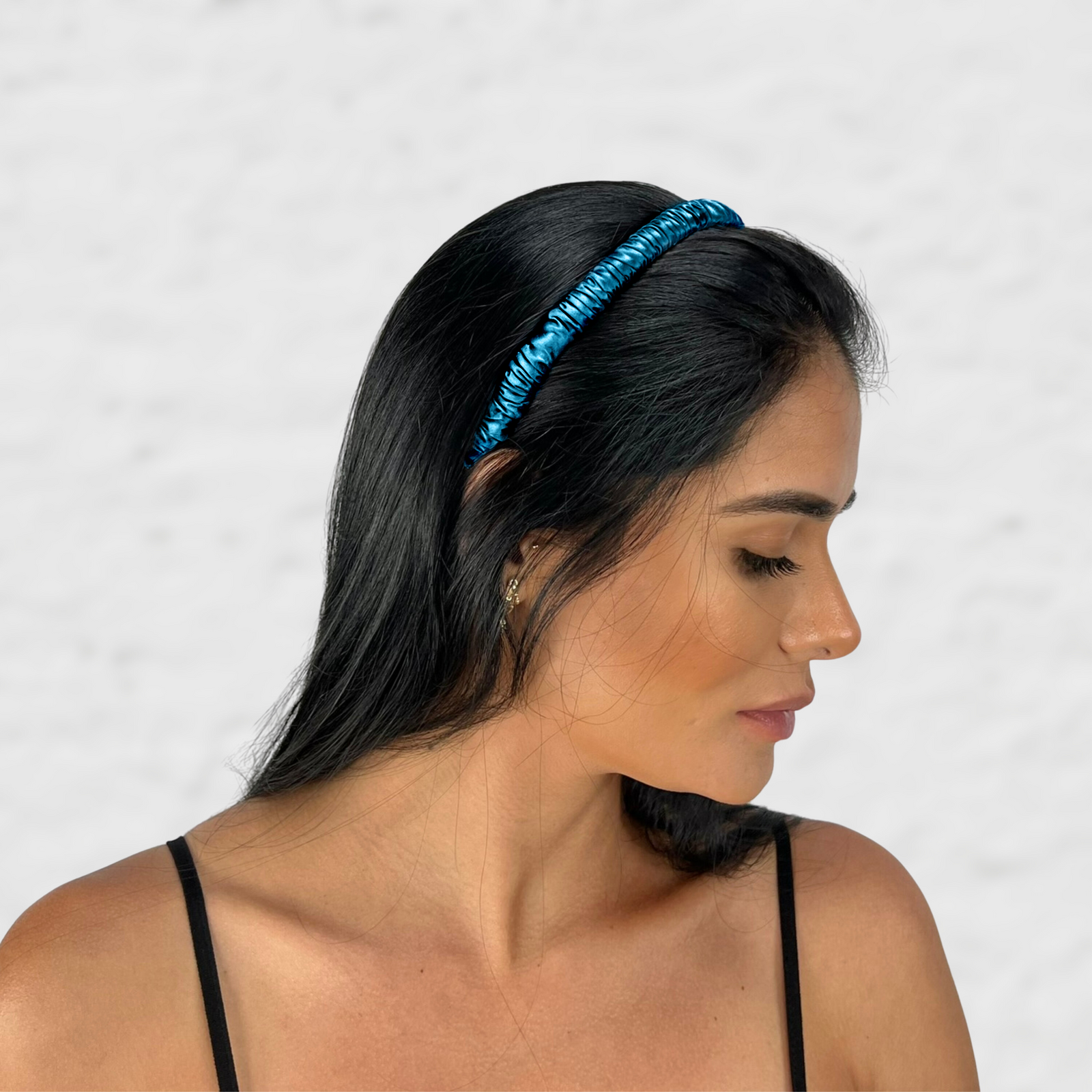 Close-up of a woman styling hair with a soft and elegant looking mulberry park silk headband