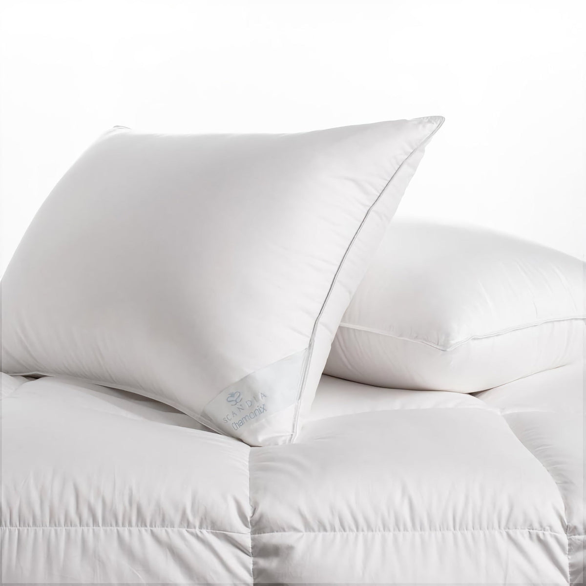 White comforter and pillows on a white background